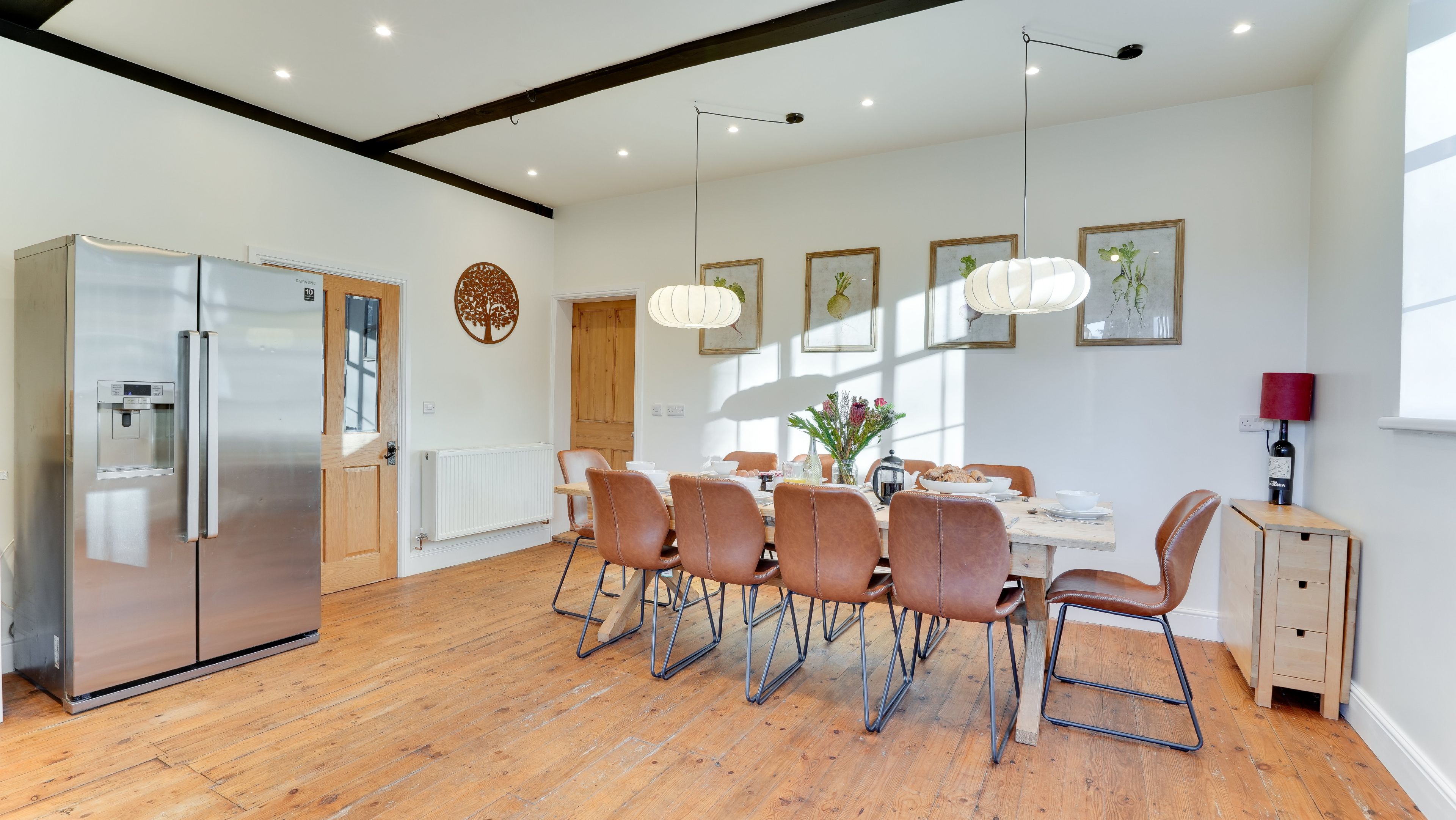 Generous kitchen with a 10-seater dining table and space for all 20 guests