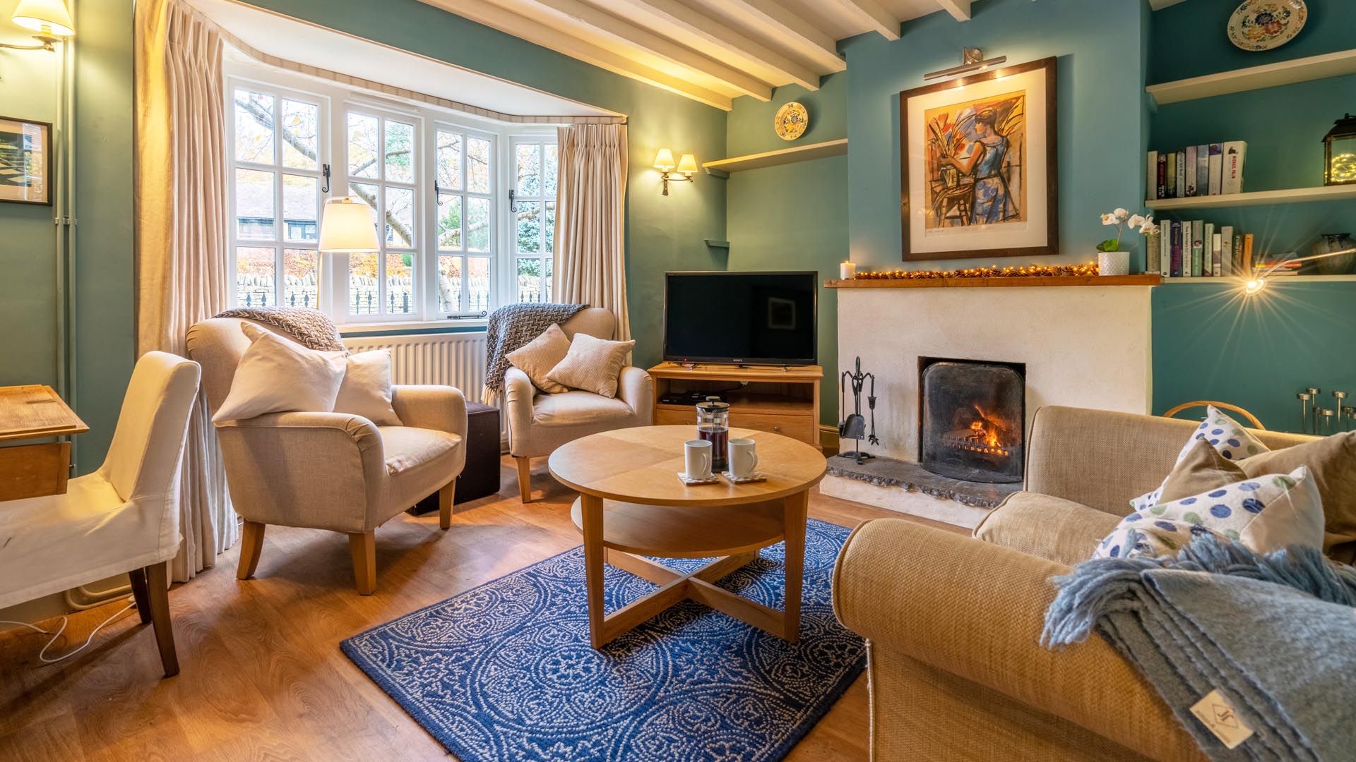 The charming living room with log fire, Manor Lodge Cottage.