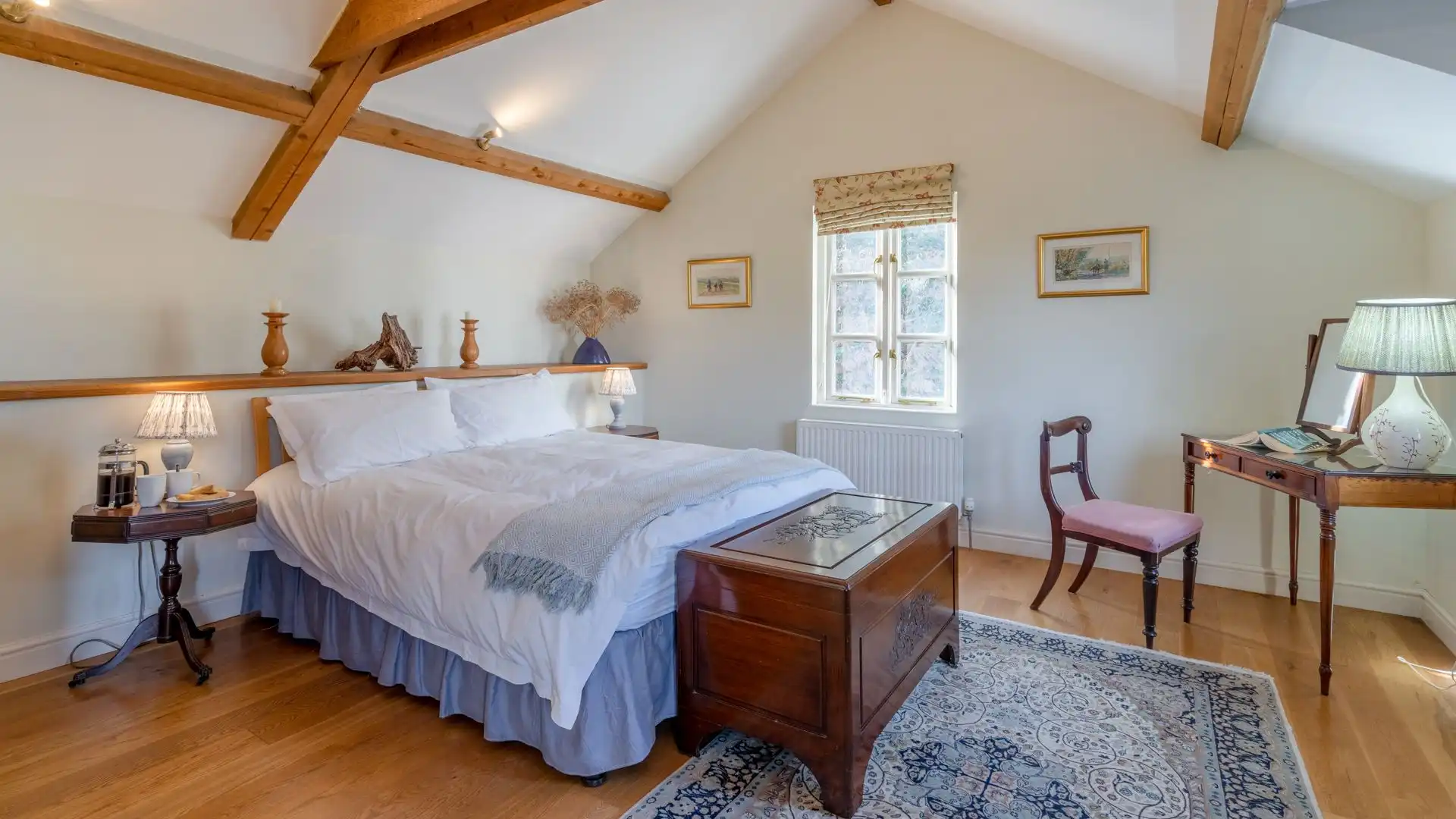 Bedroom one has a king-size bed beneath A-frame beams.