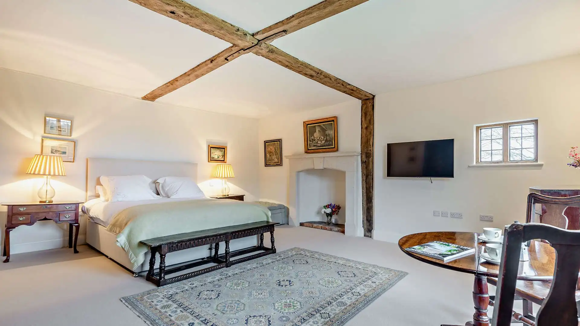 A super king-size bed sits beneath the exposed wooden beams in bedroom one