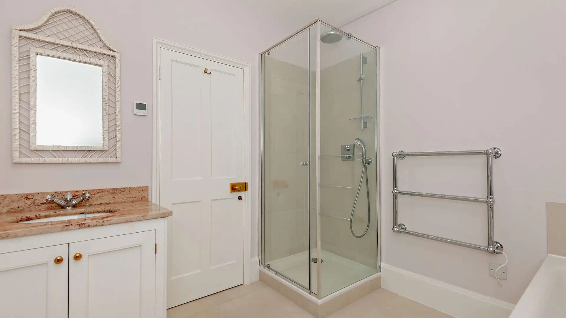 Opposite bedroom two this bathroom has a rainfall shower and a separate bath