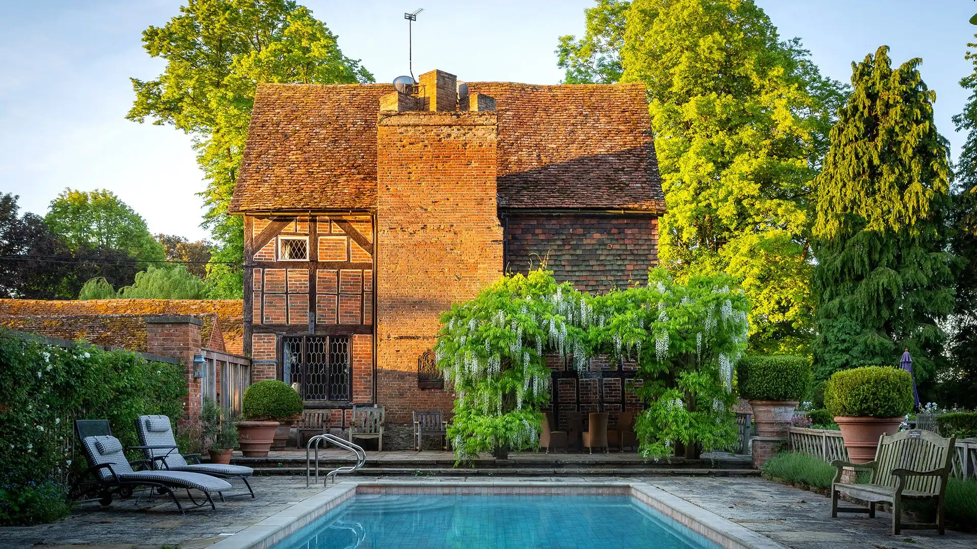 Spend sunny days poolside amongst the blooming wisteria