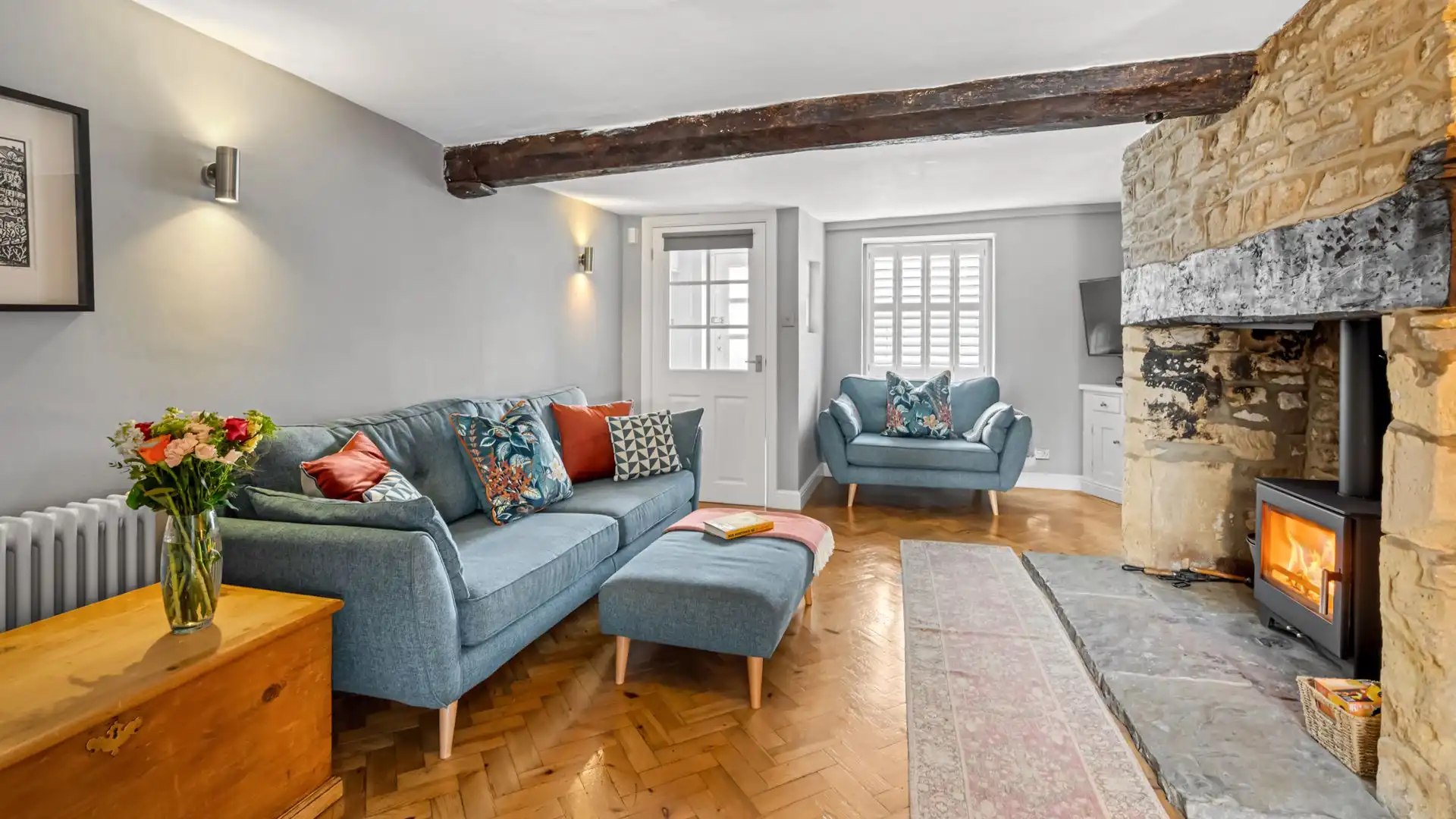 The living room is light and airy with stylish details, Horsefair Cottage.