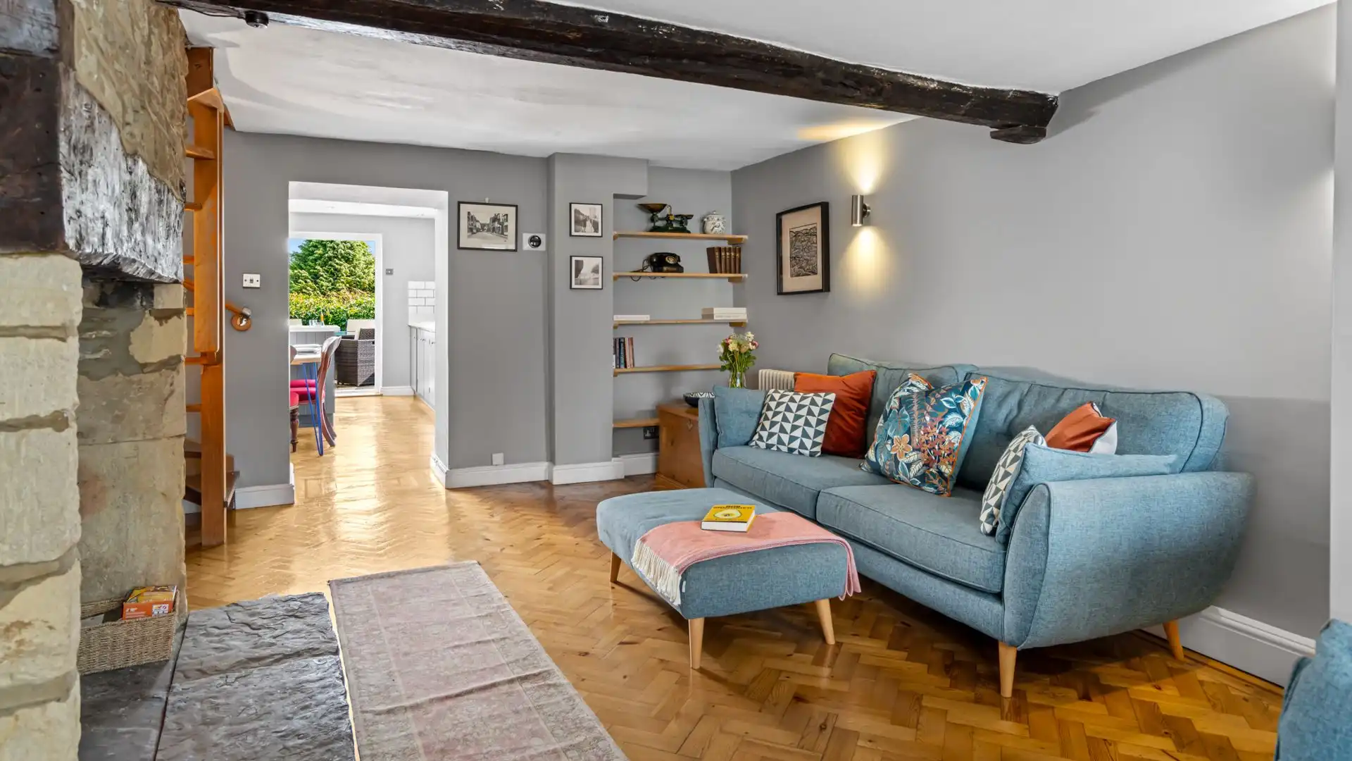 Soft blue sofas await as you relax in front of the fire, Horsefair Cottage.