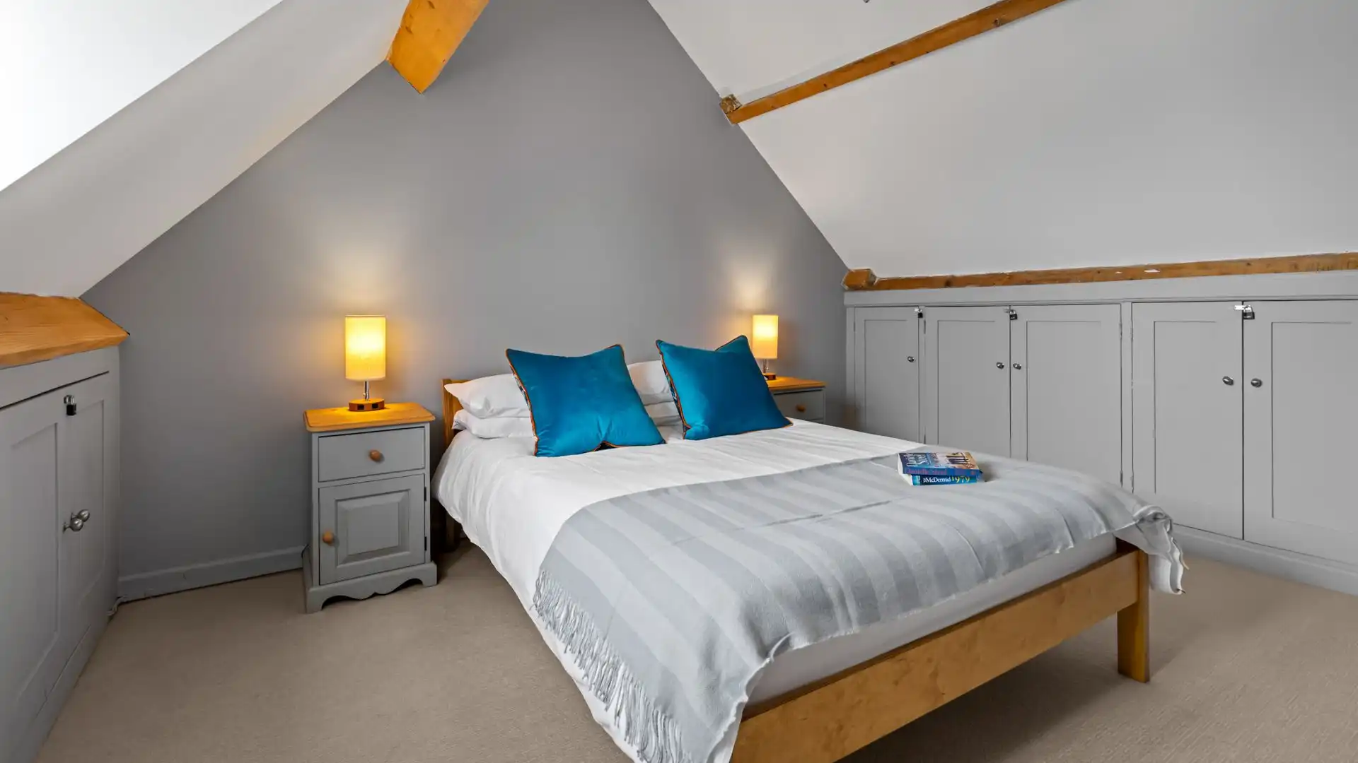 Bedroom two has exposed beams, Horsefair Cottage.
