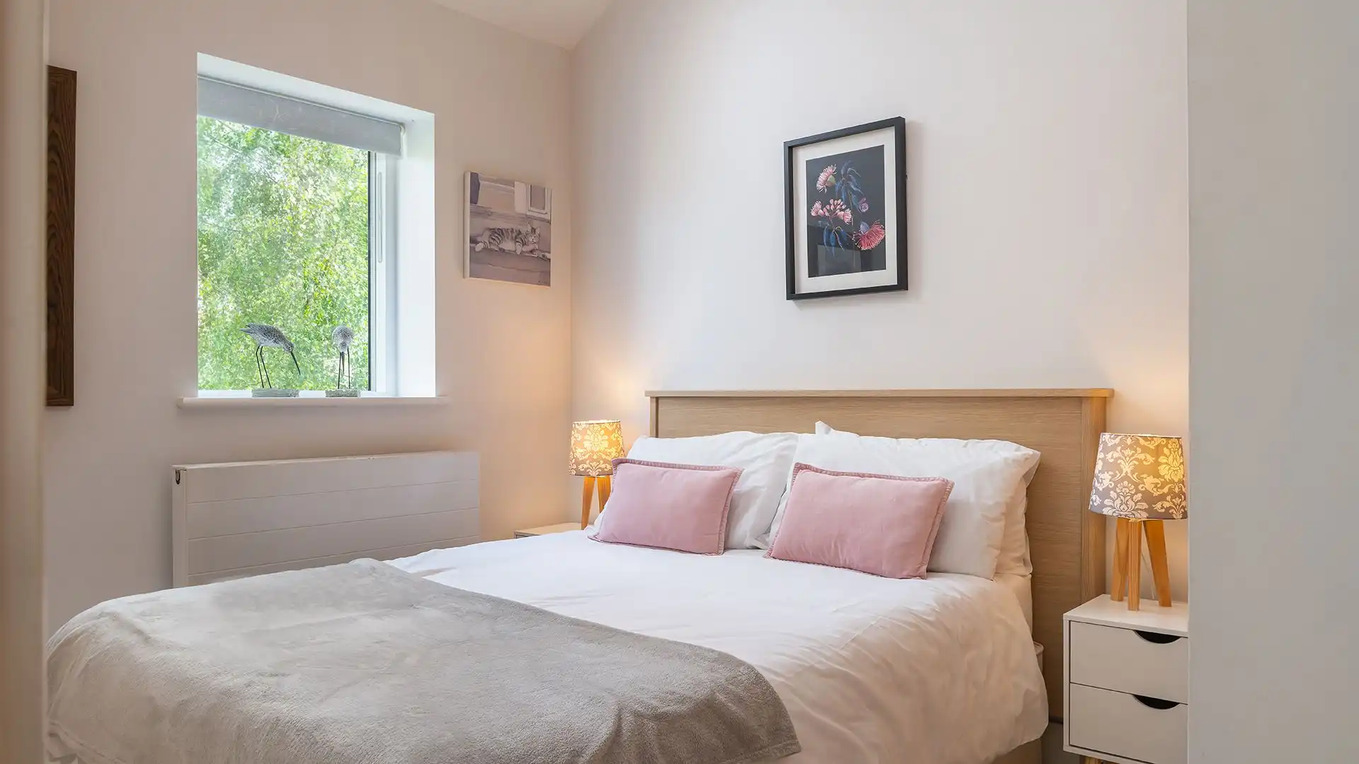The double bed has a bedside table to each side and a built-in wardrobe for storage