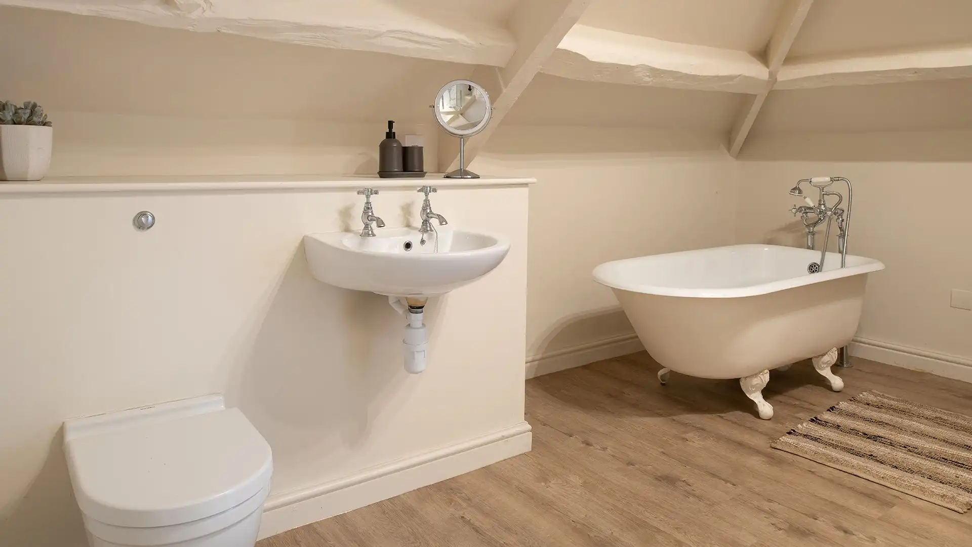 The shower has a rainfall head and the freestanding bath gives a touch of luxury to a relaxing bathe.
