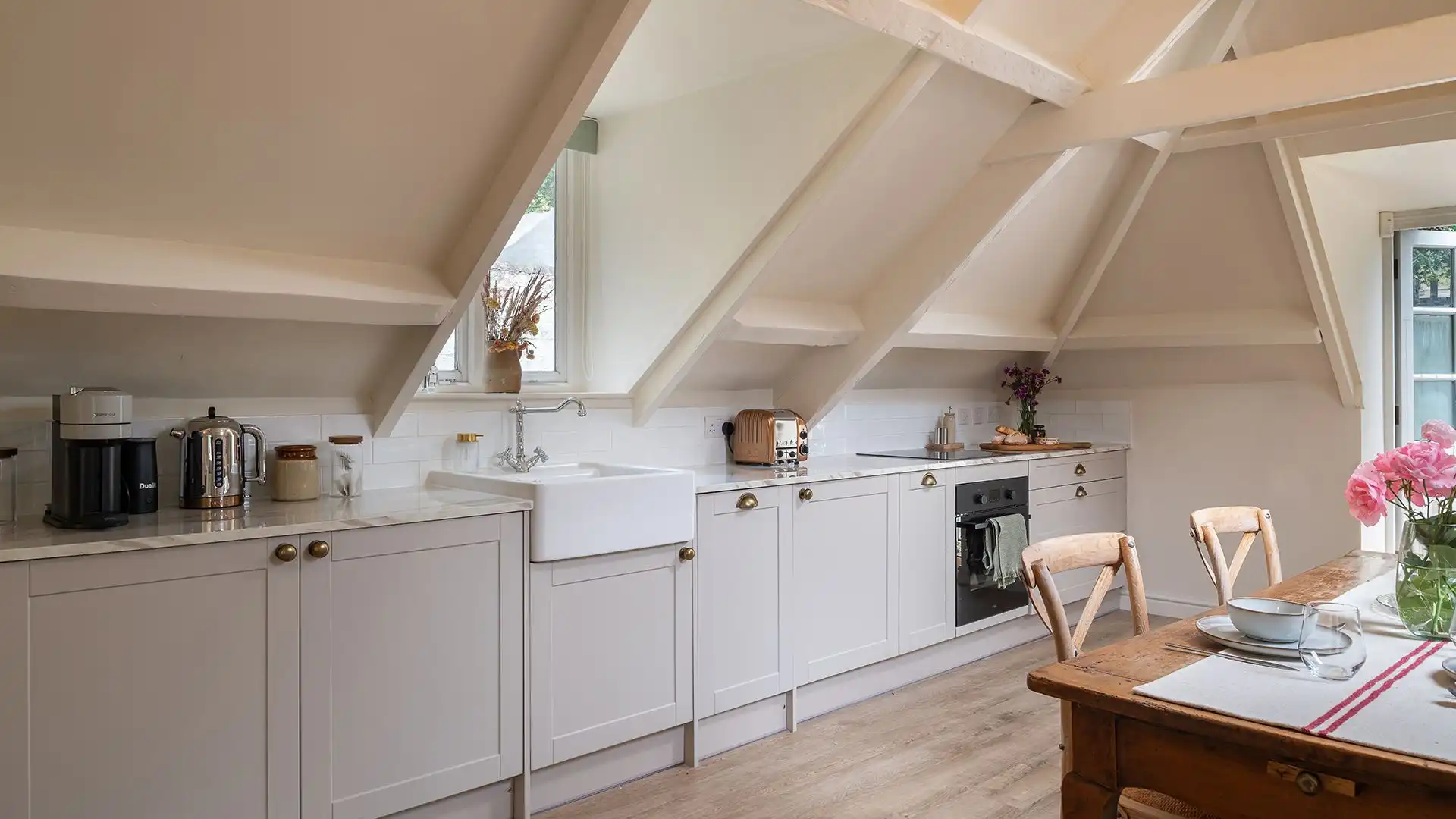 Set along one side of the open plan area, the kitchen has an oven and hob, dishwasher, fridge, Nespresso coffee machine, kettle and toaster. 