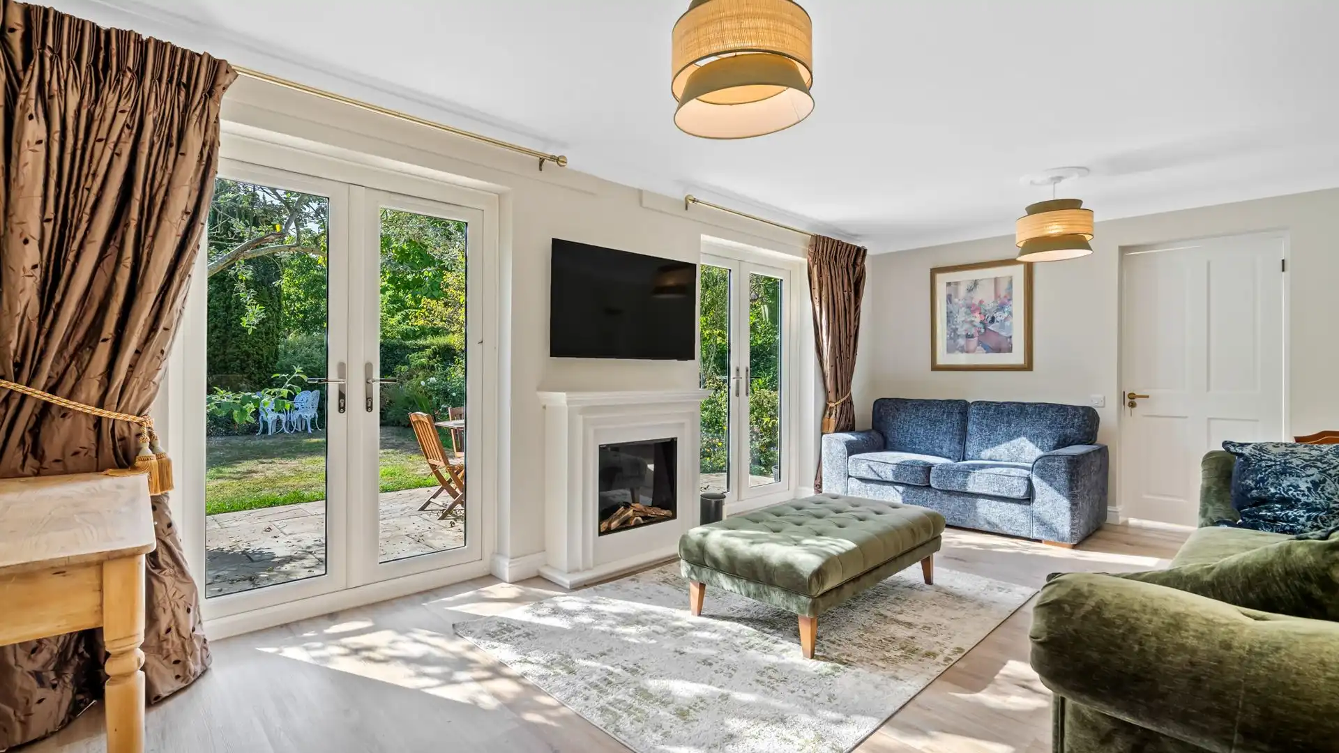 The main sitting room is spacious and bright with French doors opening to the garden.