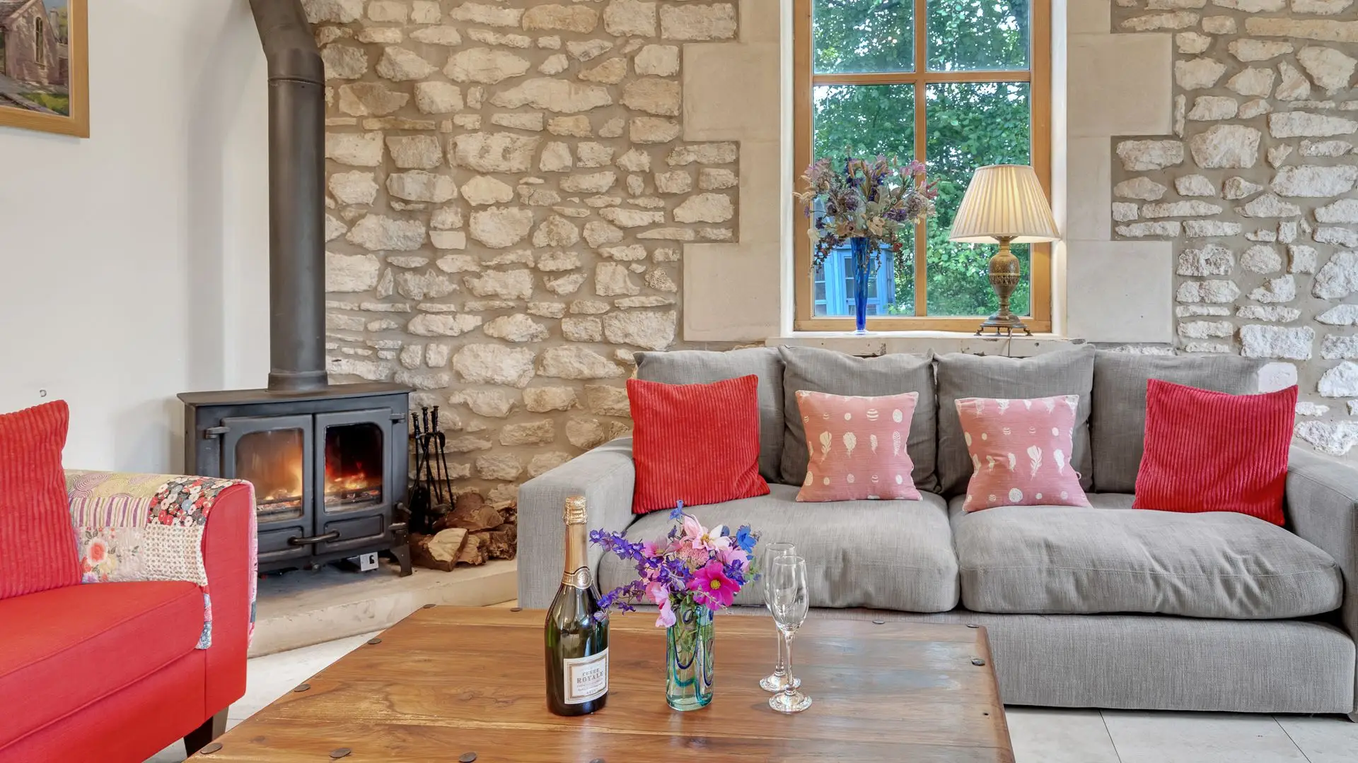 This room is dominated by a soaring arched window set in Cotswold stone.