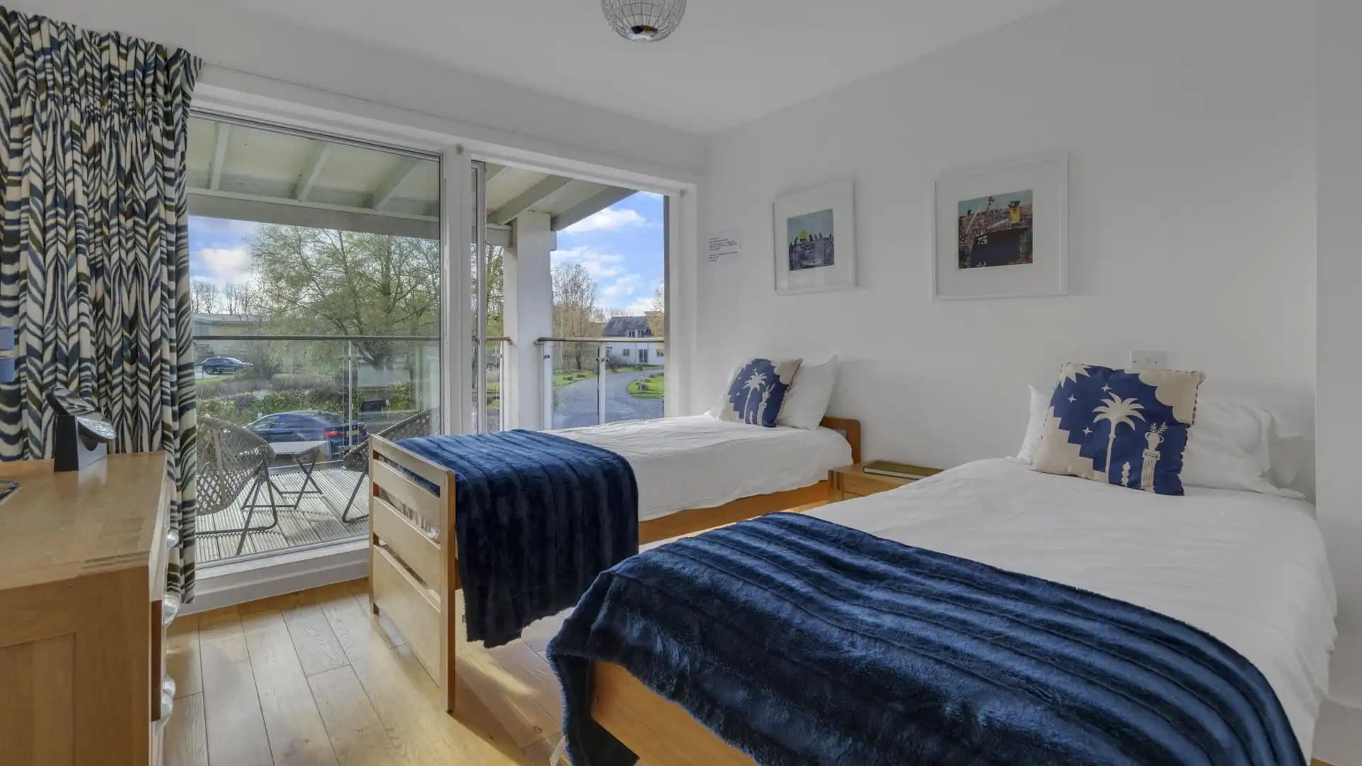 The first floor bedroom has two single beds and has a sliding door out onto the front balcony.