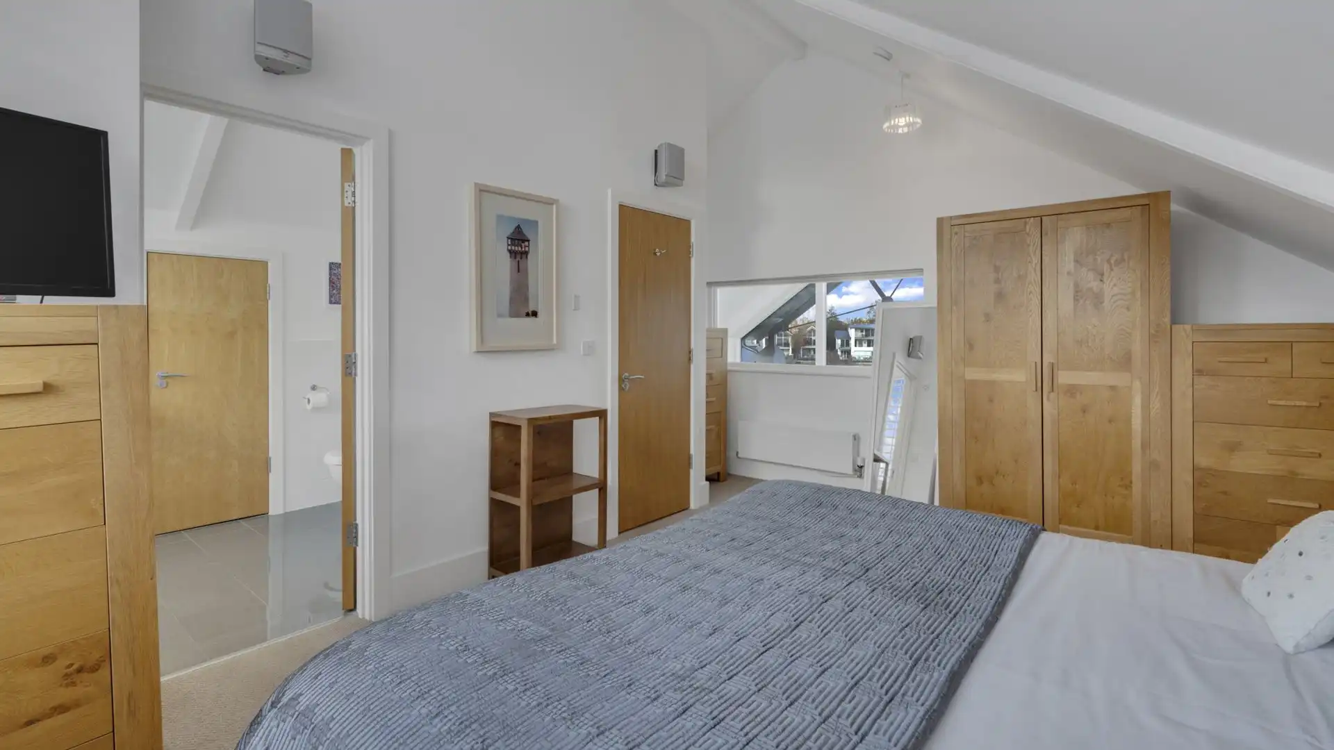 An internal window looks over the open plan area across the lake.