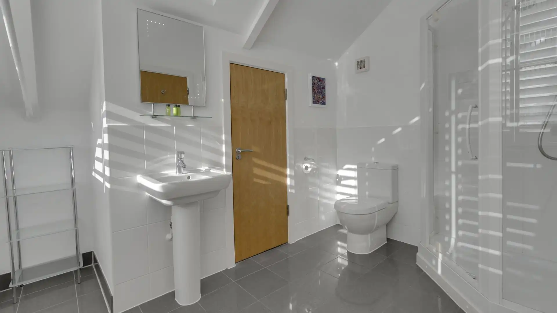 Bedroom one's en-suite is a spacious shower room with a shower, WC and basin.