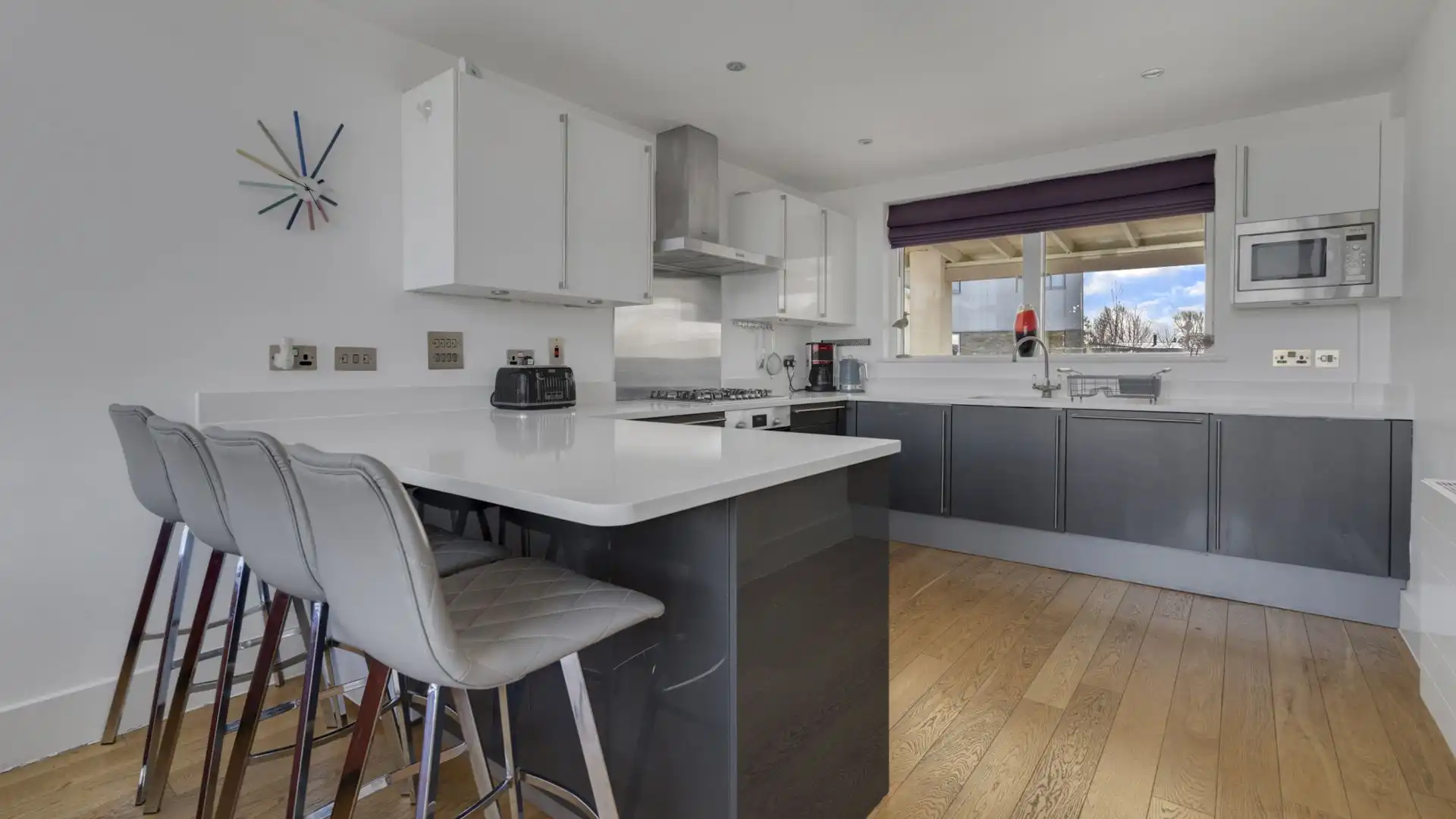 A breakfast bar seating four separates you from the sitting area.