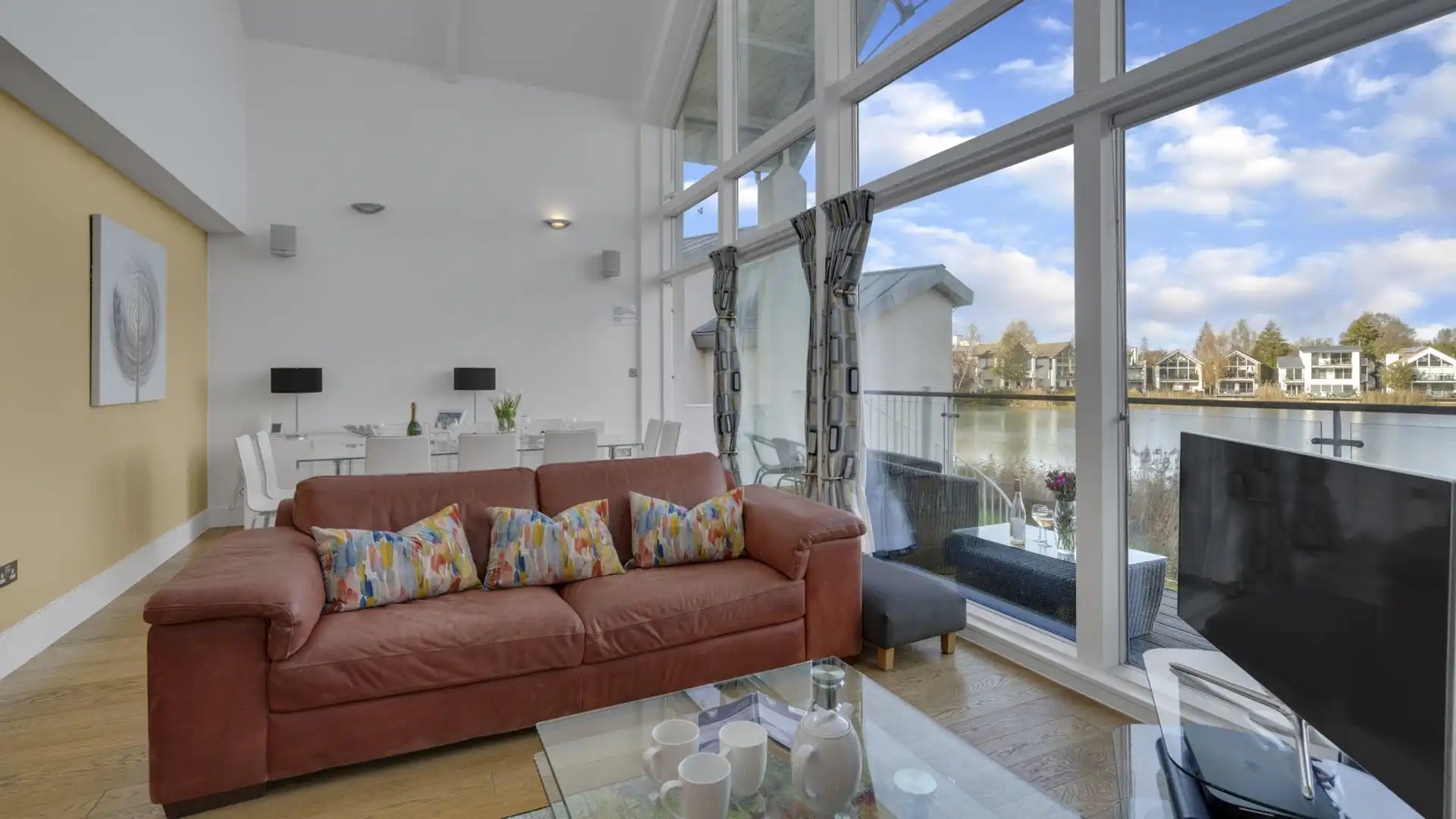 Two sofas face the woodburning stove and Sky is included on the smart TV.