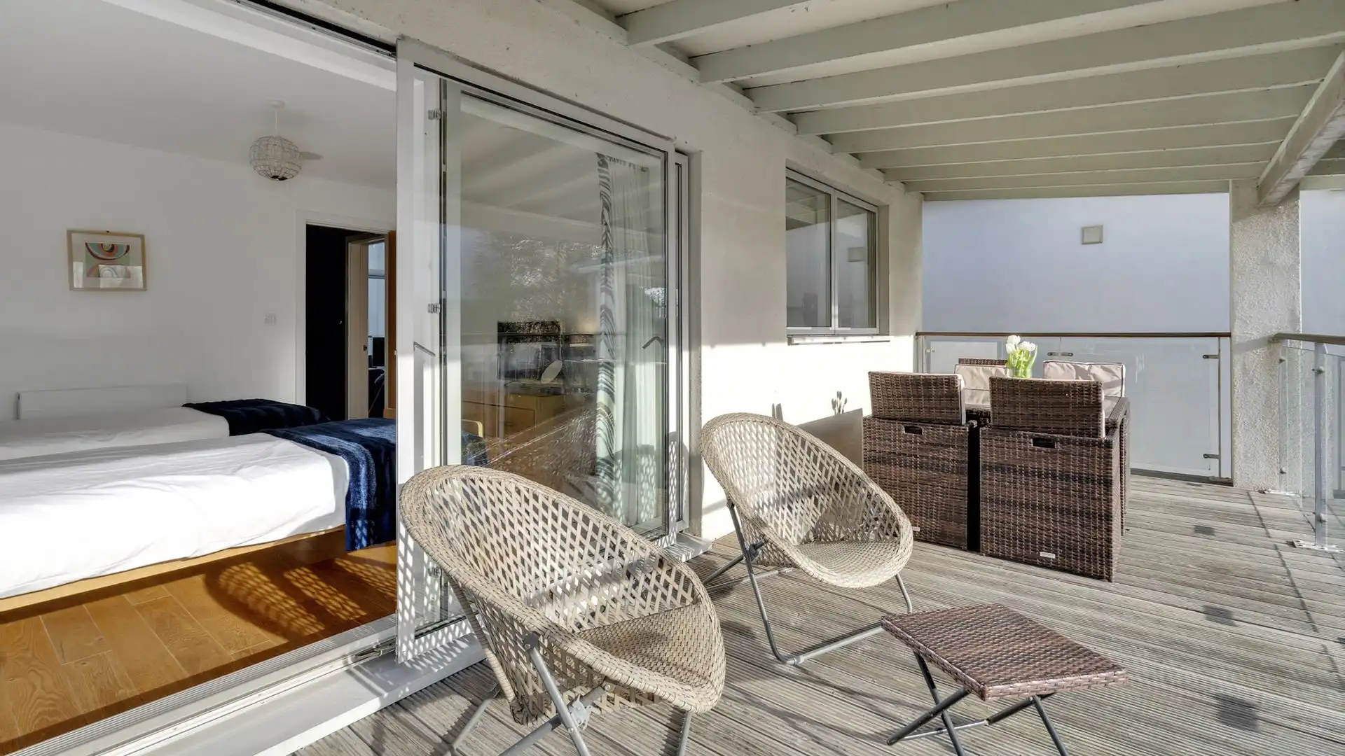 The front balcony has a coffee table and chairs.