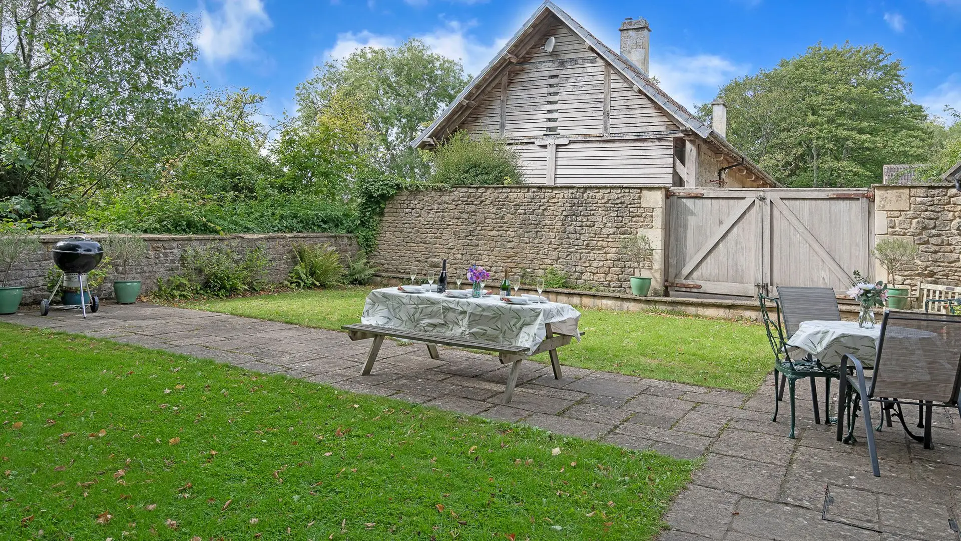 The private walled garden has space to eat together and have a BBQ.