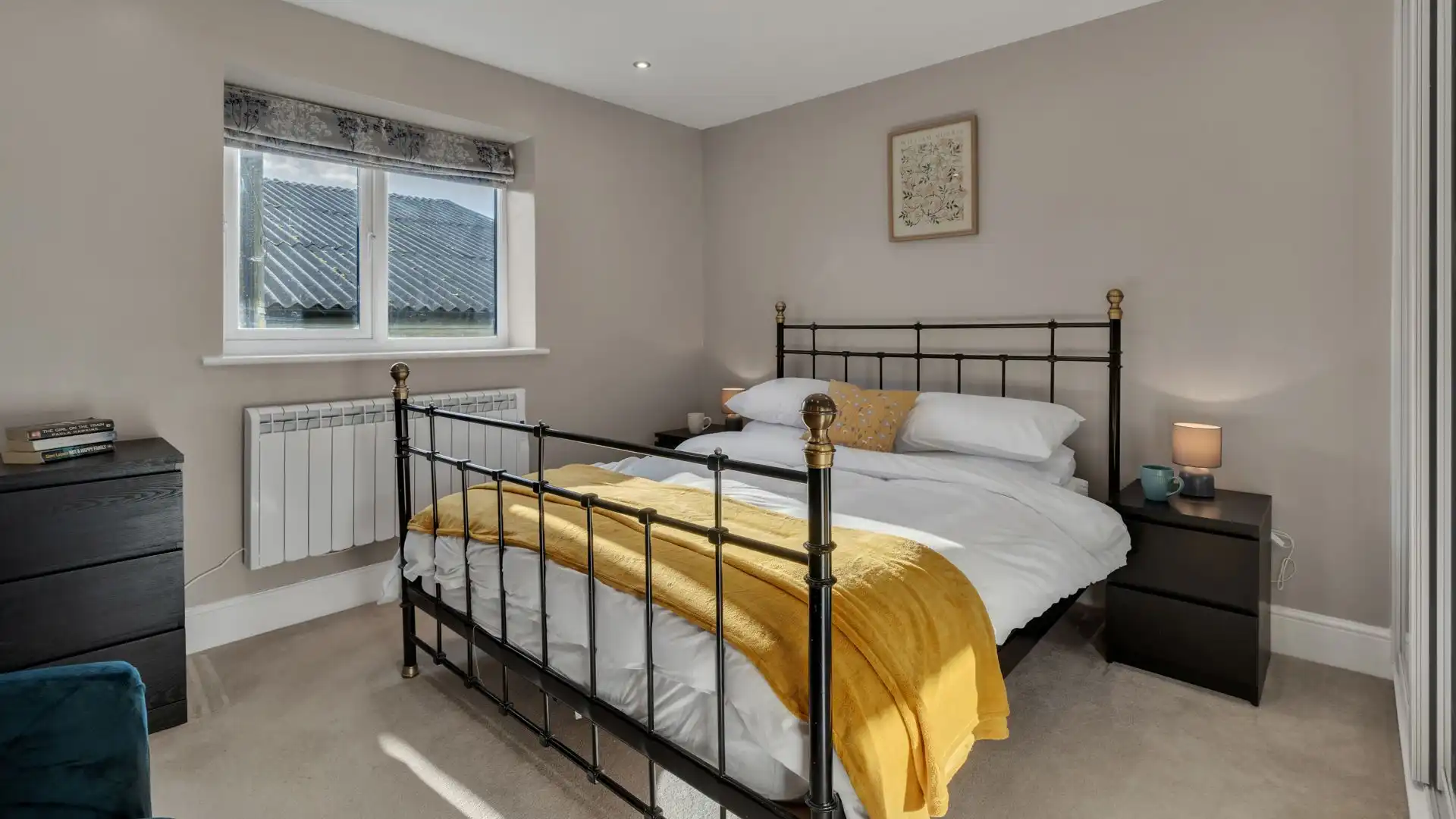 The master bedroom features a comfortable king-size bed between two bedside tables. 