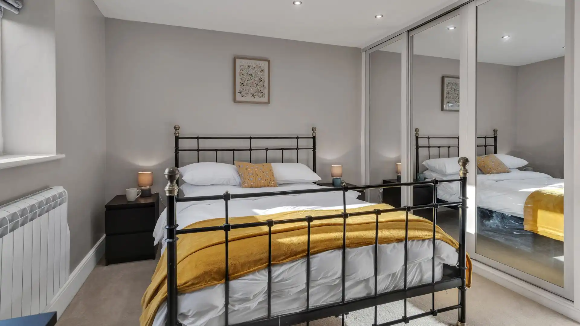 The second bedroom also features a large built-in wardrobe and chest of drawers.