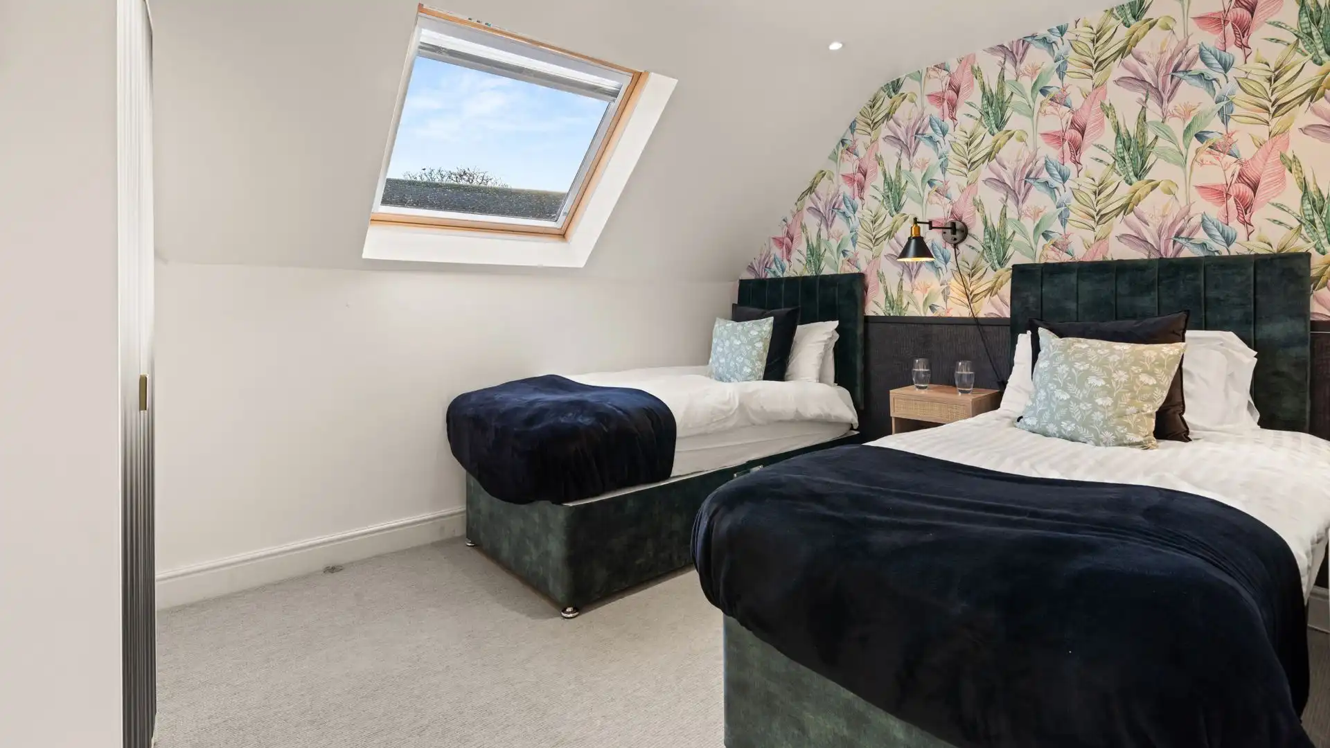 Bedroom five has two single beds sitting opposite the wardrobe. 