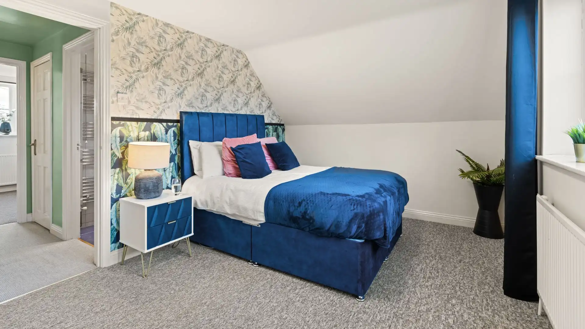 Looking across the garden to the fields beyond, bedroom one has a king-size bed. 