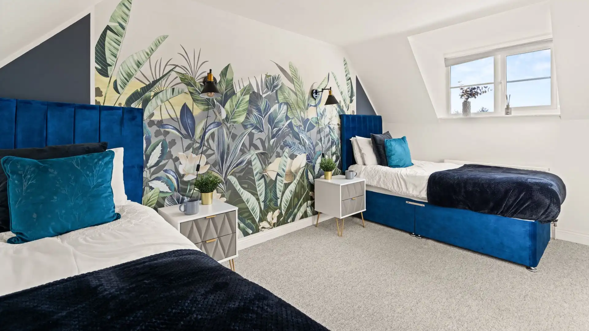 In bedroom four, two single beds sit at each side of this bedroom with a bedside table each. 