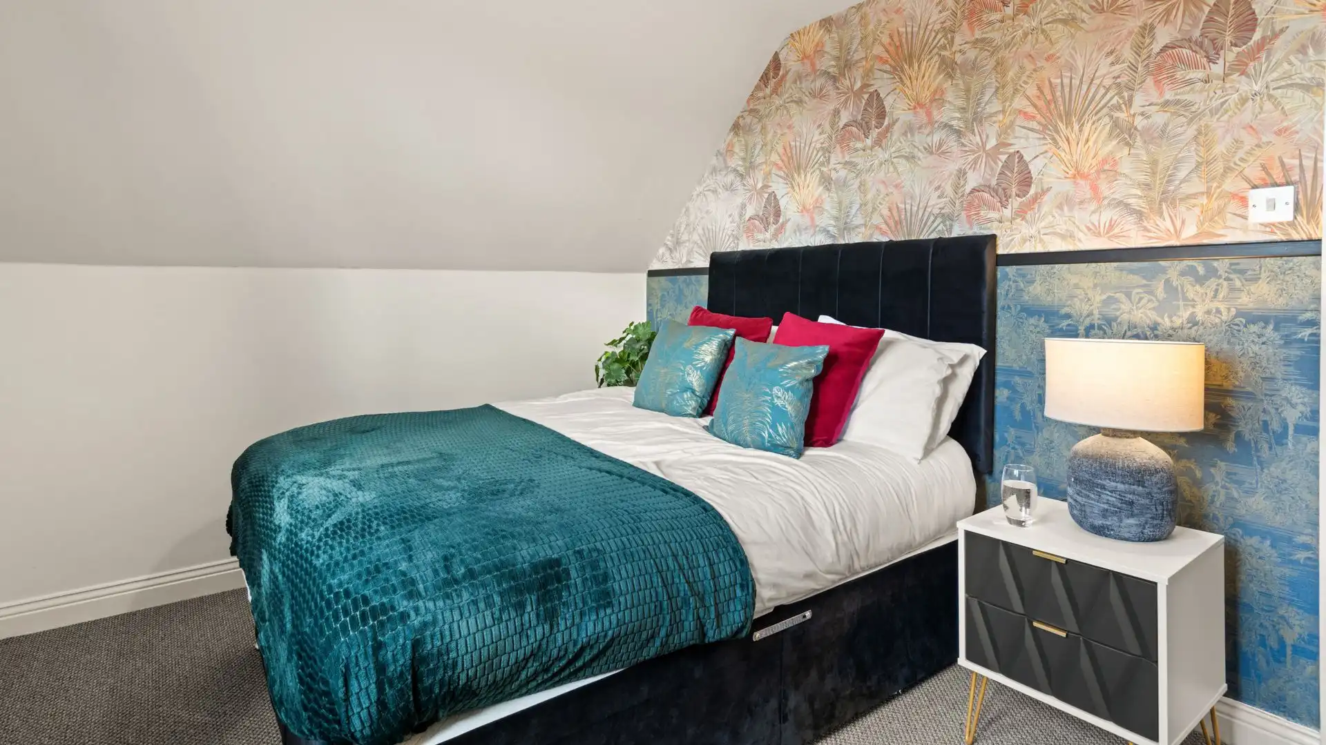 Bedroom two has a bedside table and a built-in wardrobe.