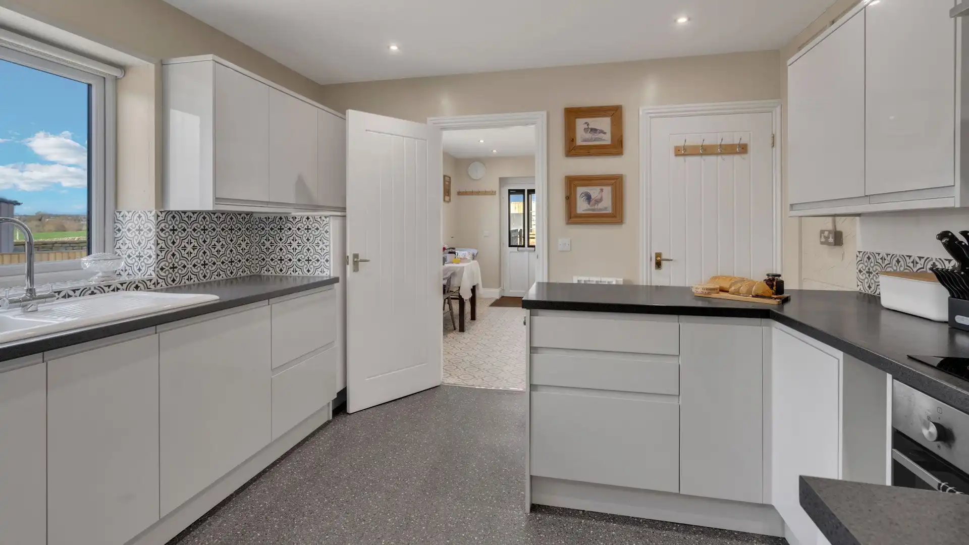 The kitchen features ample worktop space, an oven, hob, kettle and toaster.