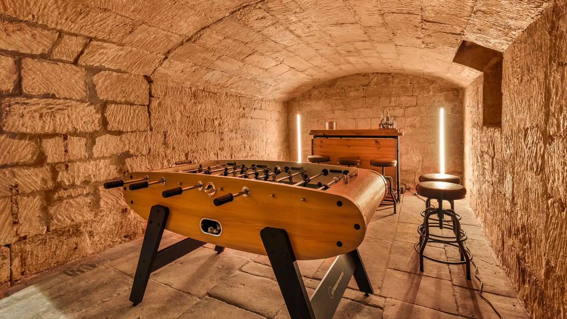 The cellar has been converted into an ultra trendy bar complete with foosball table.
