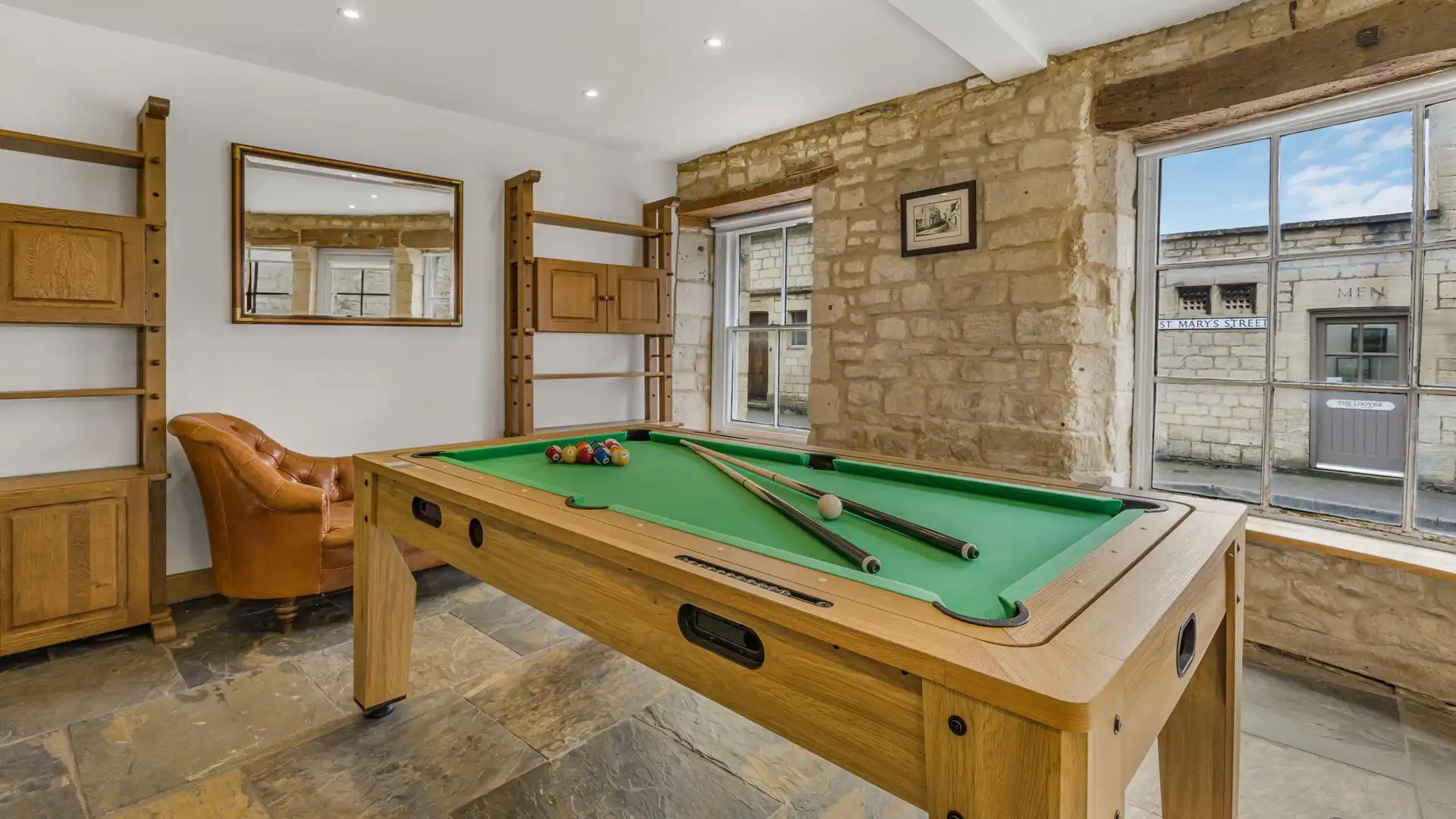 The dining table cleverly transforms into a pool table.