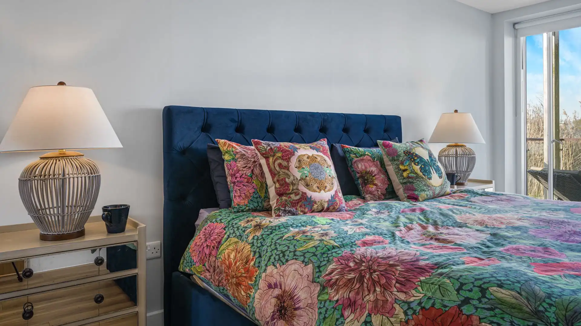 A comfortable bedroom with sliding doors opening onto the decking. 