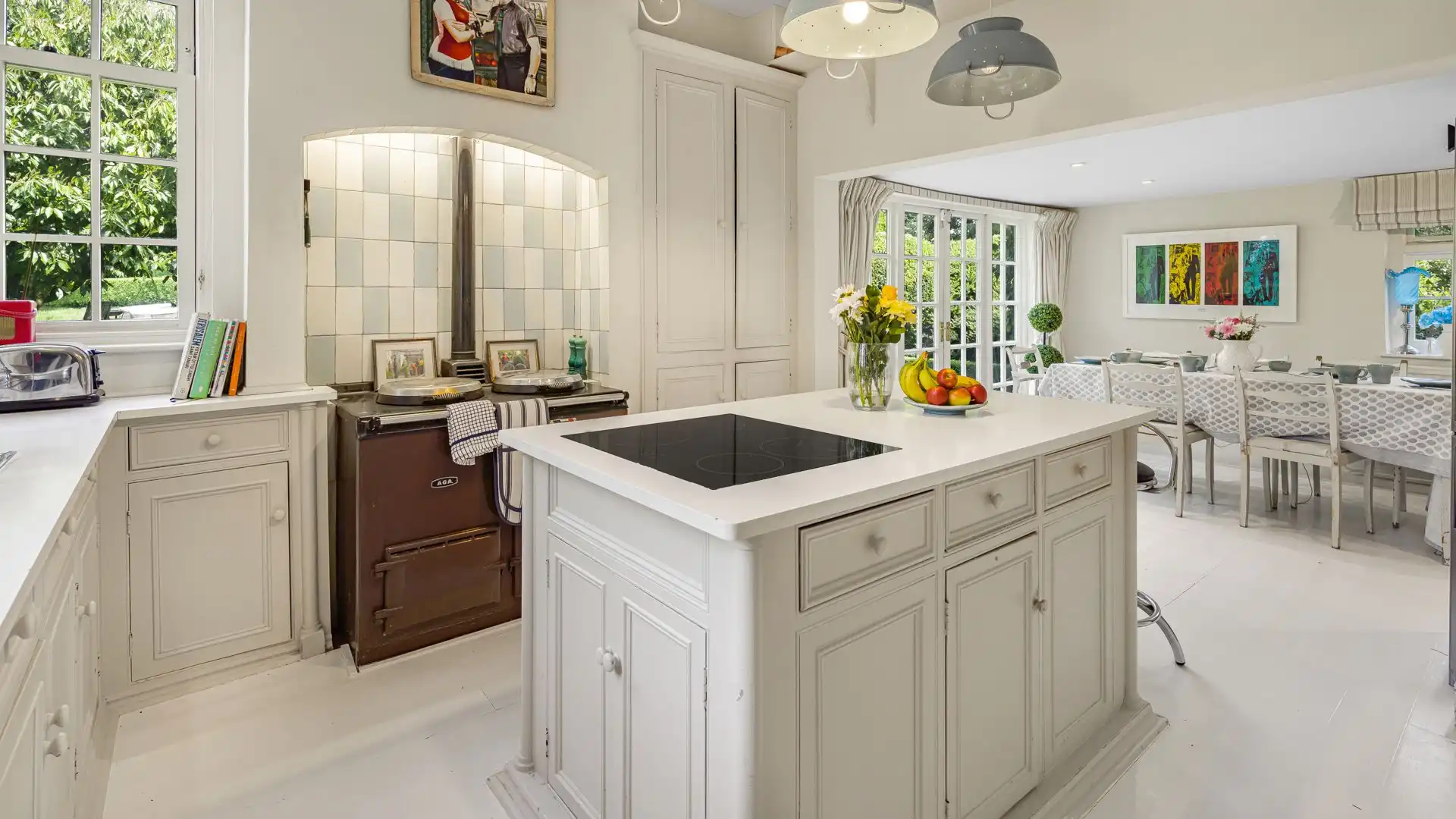 A charming country kitchen with Aga, breakfast table and patio doors leading to the garden.