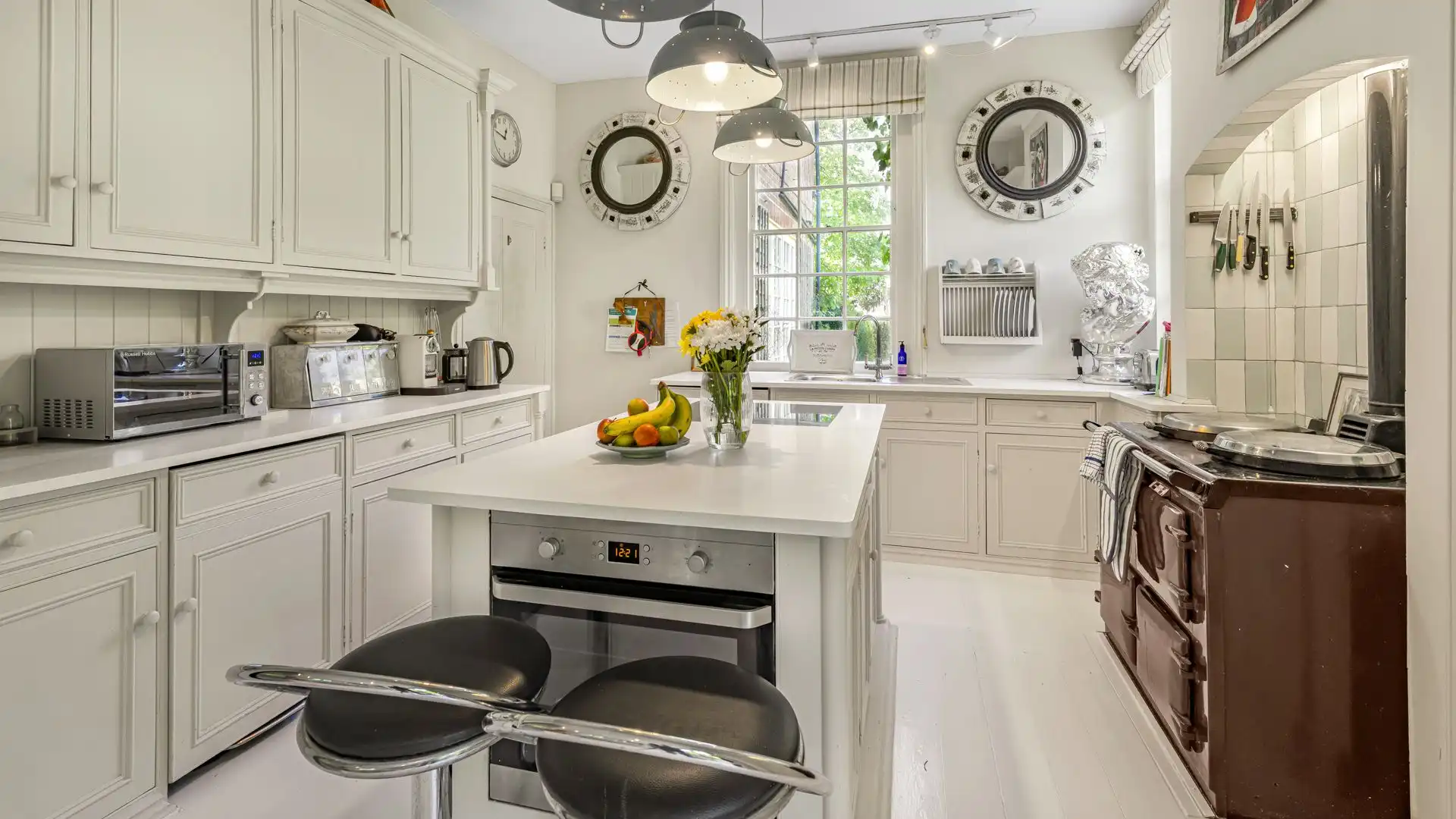 The beautiful kitchen has a traditional Aga.