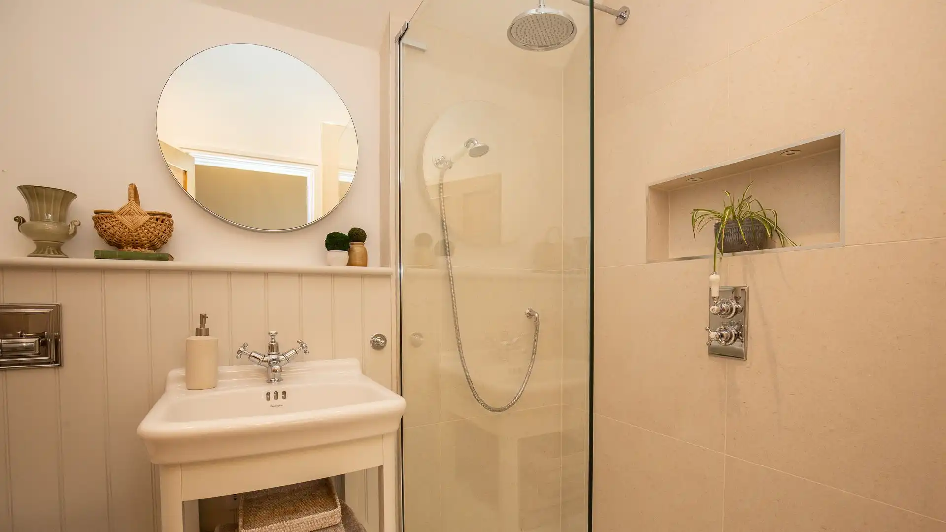 Bedroom one's en suite has a walk-in shower, basin and WC