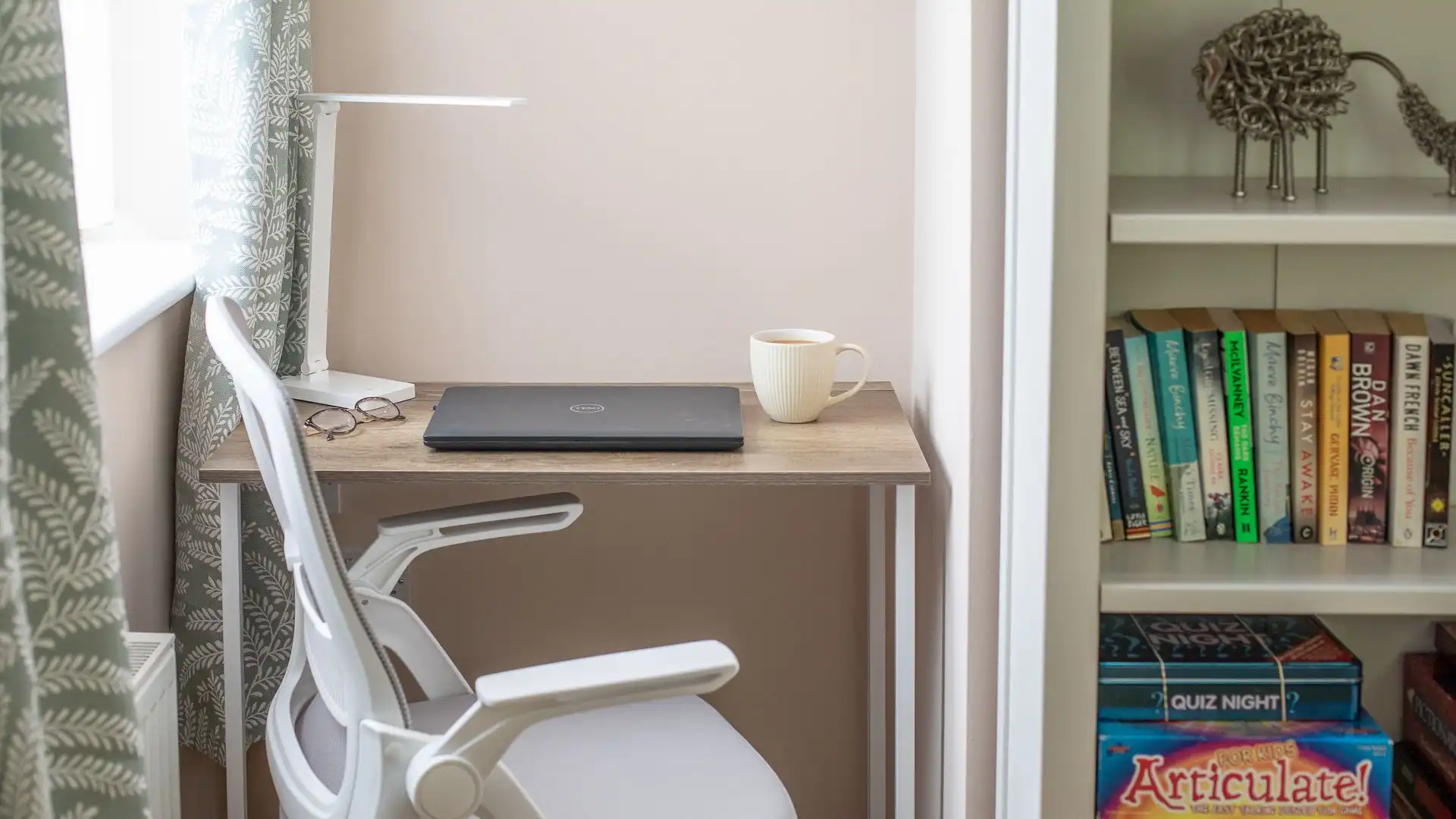 The living room features a dedicated workspace.