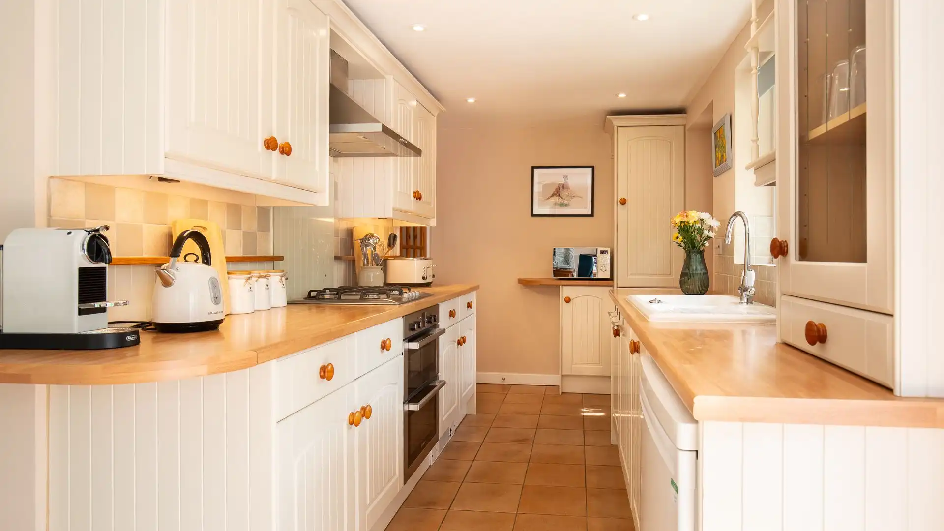 The farmhouse style kitchen features a Nespresso coffee machine. 