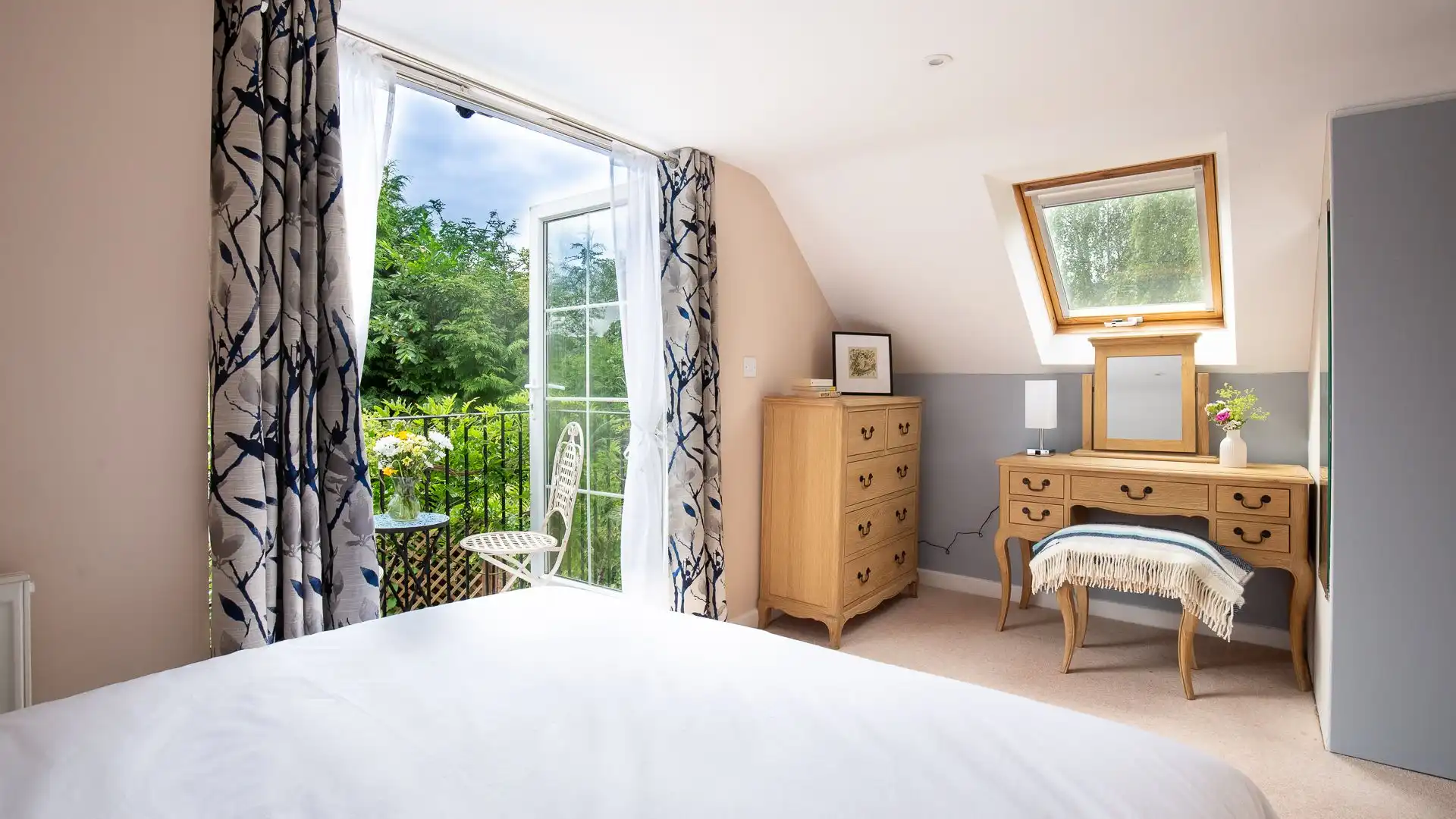 The master bedroom features a vanity desk with a mirror and chair. 
