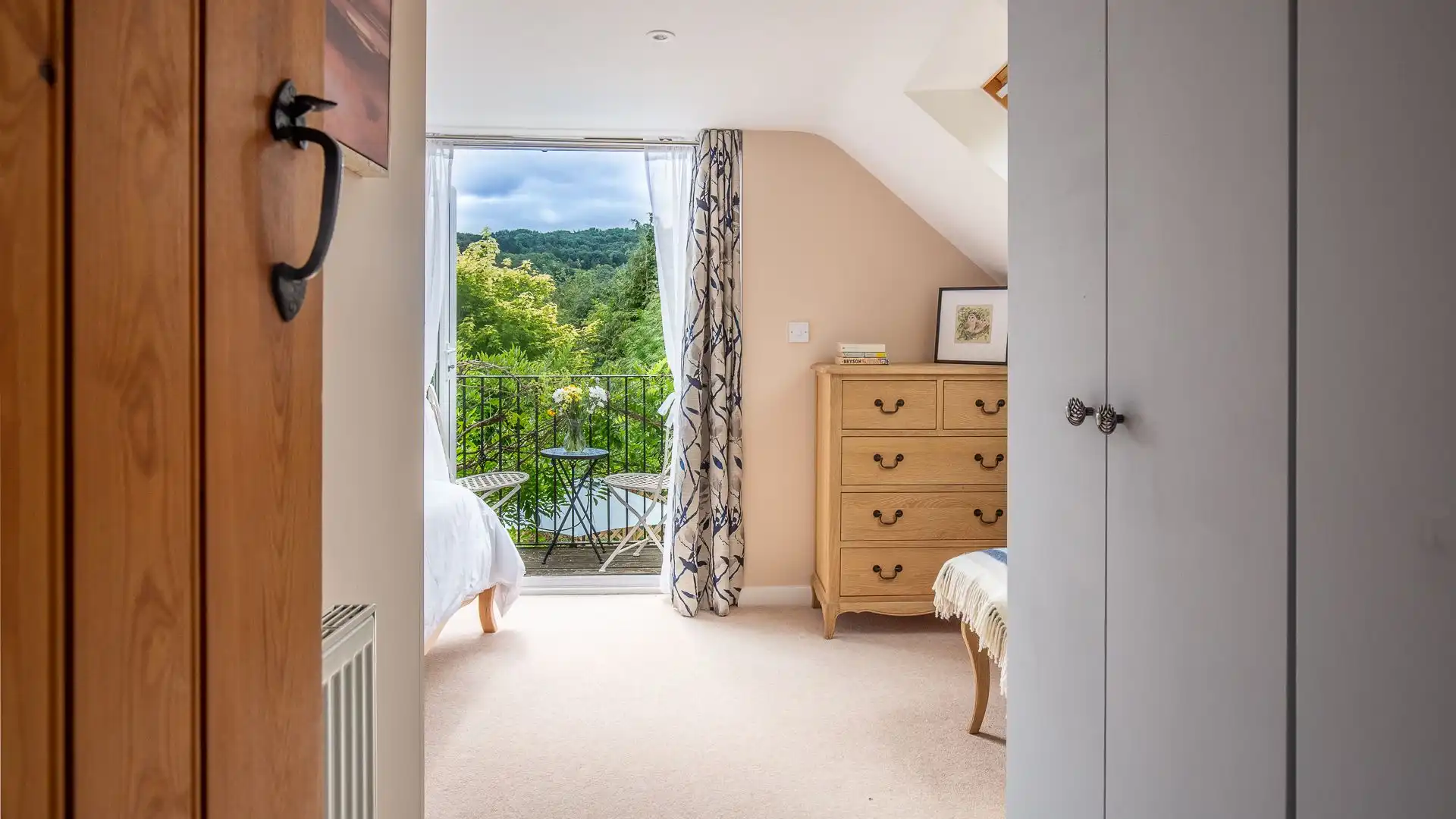 The master bedroom features a large wardrobe space and a chest of drawers for storage.
