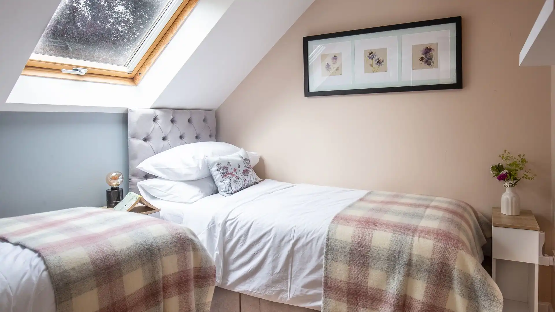 The twin bedroom features a skylight and wonderful artwork. 