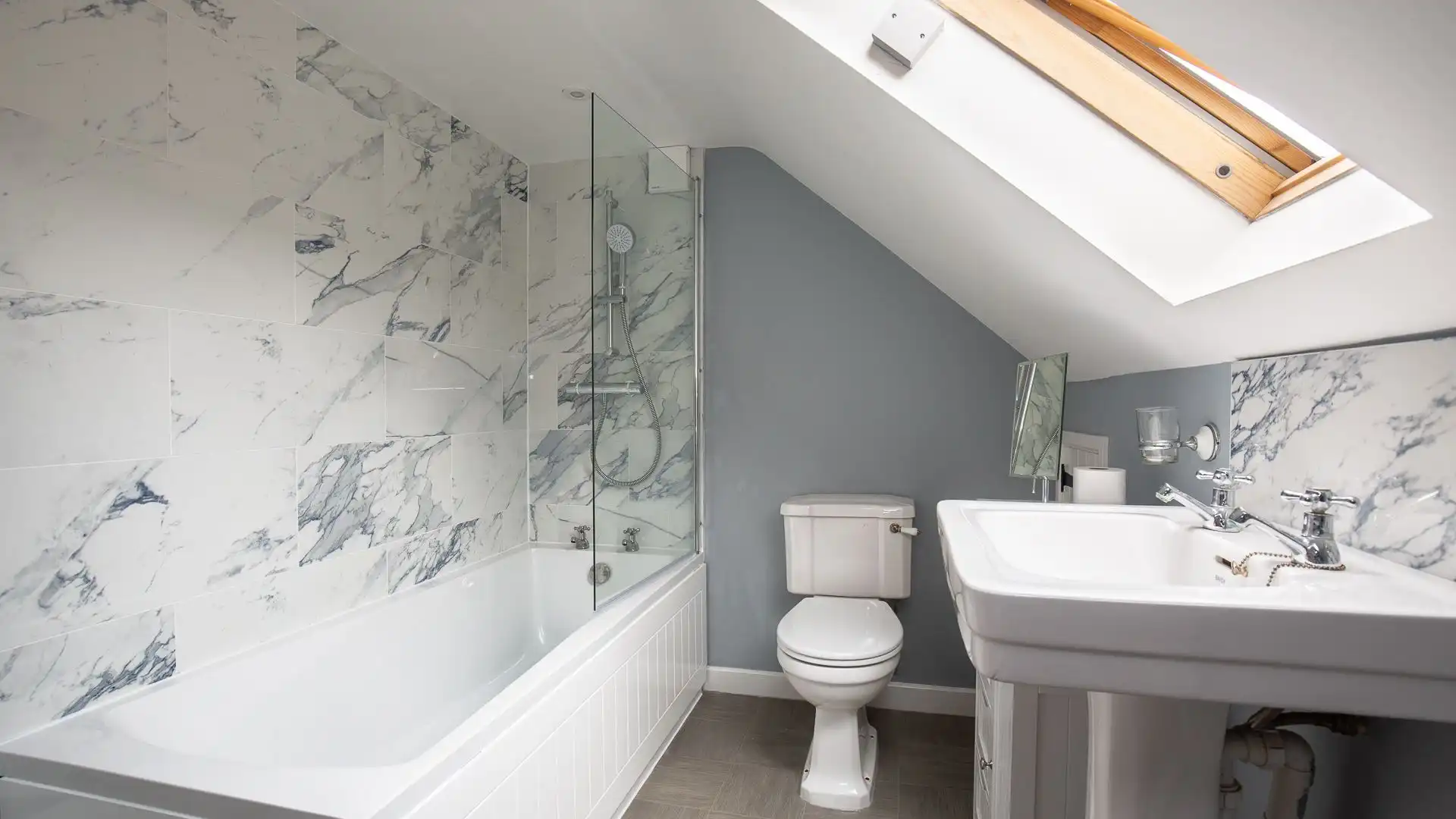 This stylish bathroom features a bath, shower, WC and basin.