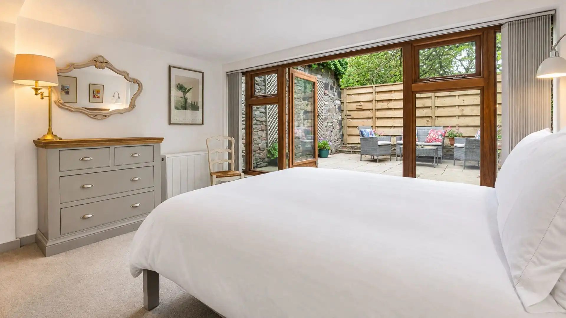 Bedroom One leads out to a quiet garden nook, East Barn.