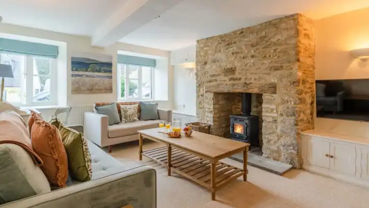 Cosy up together by the fire at Christmas Cottage in the Cotswolds.